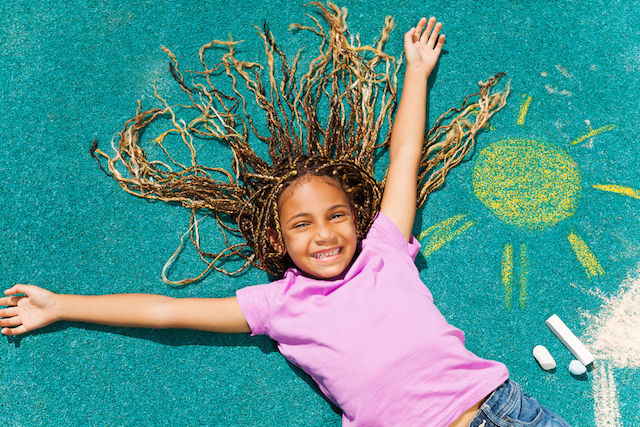Beautiful black girl with her chalked drawing
